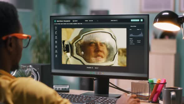 African American Guy Retouching Photo of Cosmonaut