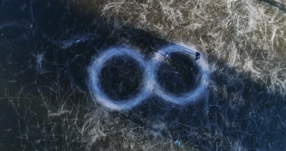 Father and son ice skating circles, infinity symbol