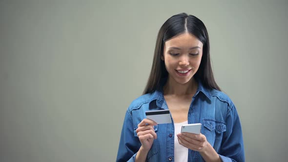 Attractive Woman Entering Credit Card Number on Smartphone, Shopping Online