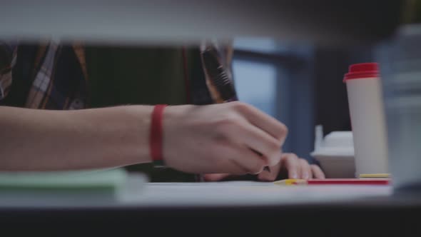 Male Hands Illustrator Draw a Marker. Coffee on the Table