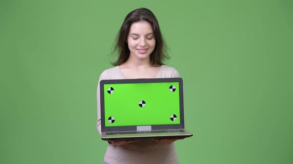 Young Happy Beautiful Woman Showing Laptop and Looking Down