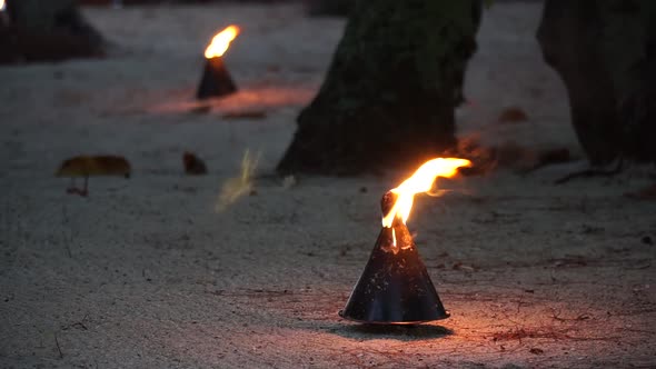 Flame burning on the beach of Bora Bora Island, French Polynesia. 