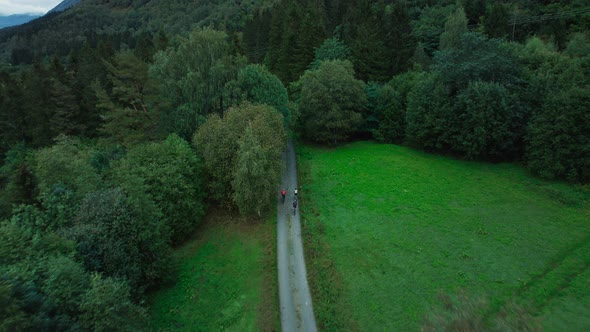 Scenic Drone Shot of Cyclists on Forest Road