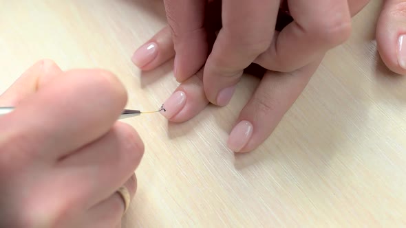 Manicurist Drawing Pattern on Nails.