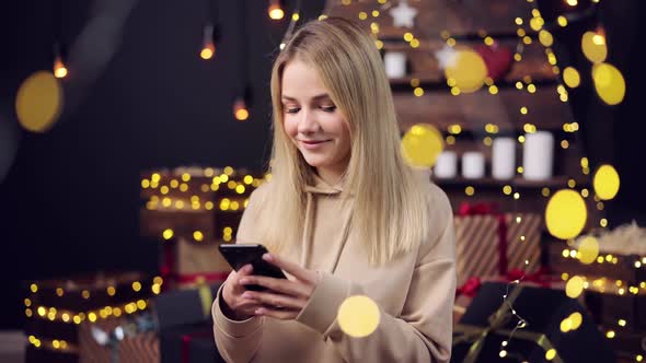 Woman Using Smartphone Glowing Garlands Around