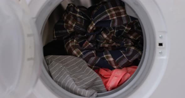 Load clothes to washer machine