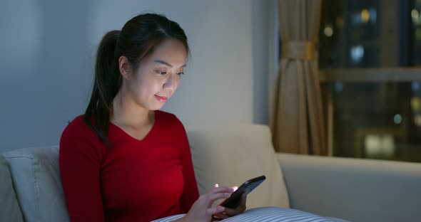 Woman use of smart phone at night