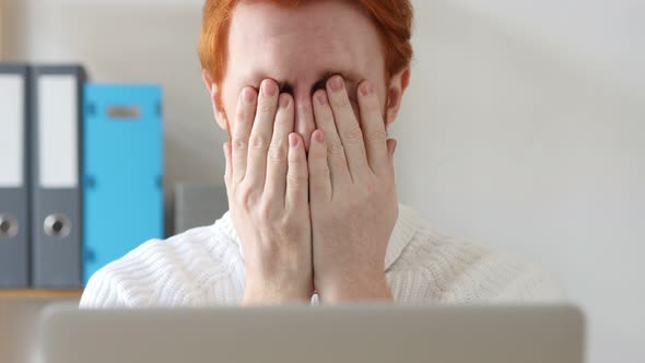 Upset Young Man with Red Hairs  at Work