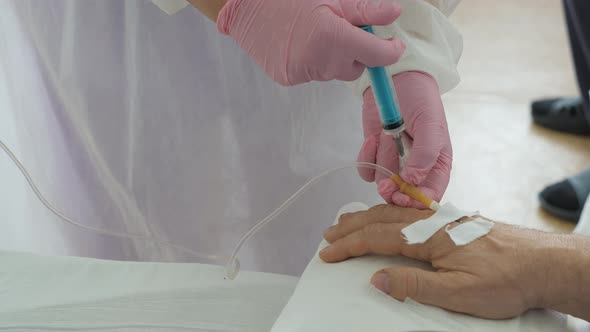 Injection of Medication Through a Dropper Installed in the Person's Hand.