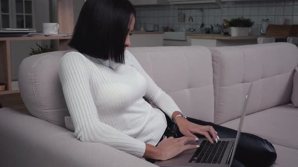 Woman with laptop working at home office