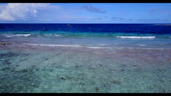 Aerial flying over nature of marine island beach lifestyle by blue ocean with bright sandy backgroun