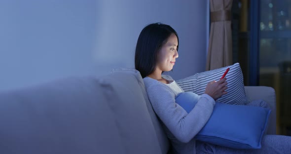 Woman read on smart phone in city at night