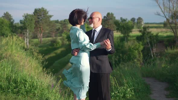 Side View Loving Couple Dancing in Sunshine in Spring Summer Park Outdoors