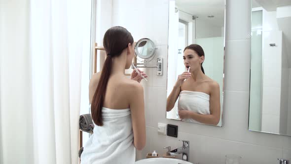 Dental Health. Woman Brushing Teeth In Bathroom