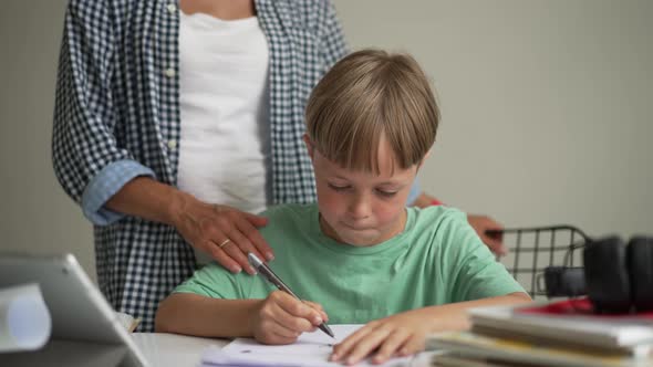 Mother and 8 Year Old Son Doing Homework