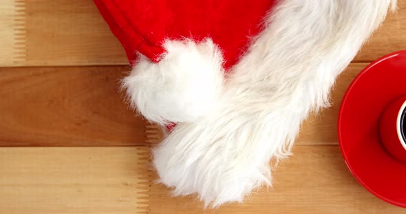 Close-up of coffee cup with saucer and santa hat 4k