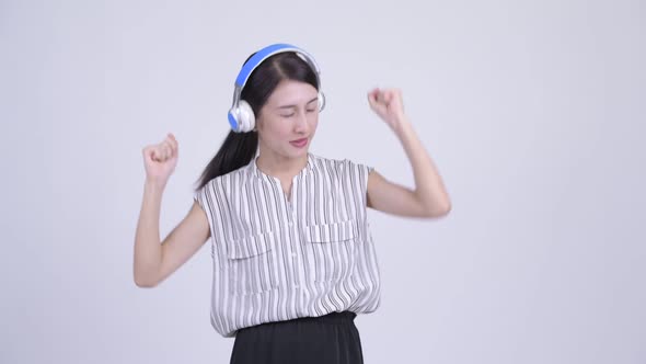 Happy Beautiful Asian Businesswoman Dancing While Listening To Music