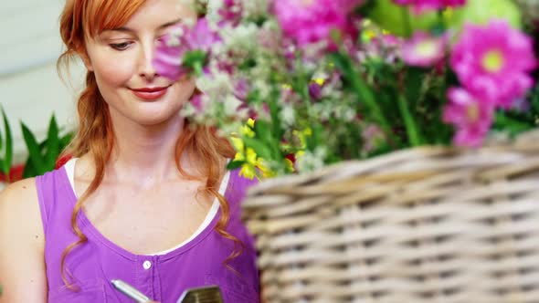 Female florist writing on clipboard