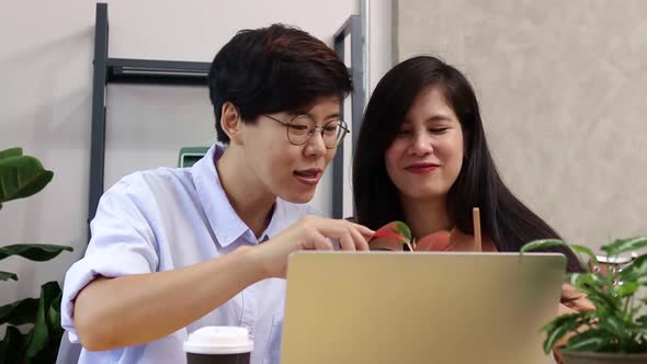 Asian LGBT couples work together at home.