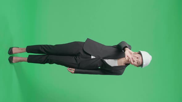 Full Body Of Upset Asian Female Engineer Showing Gesture Hands Palm In The Green Screen Studio