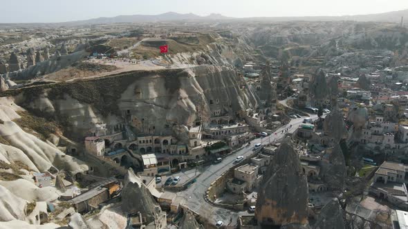 Aerial shot of Cappadocia hotels carved from stone rock, cave style.