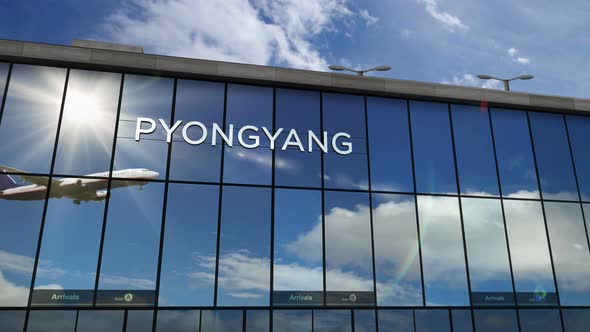 Airplane landing at Pyongyang North Korea airport mirrored in terminal