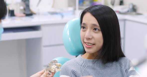 Woman dentist working at her patients teeth