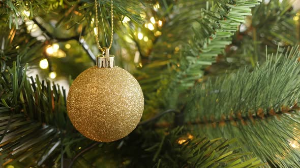 Close-up of golden color  Christmas ornament 4K 2160p 30fps UltraHD footage - Shiny fairy-lights and