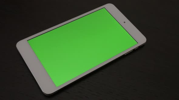 Green screen display tablet computer on table panning 4K 2160p 30fps UltraHD footage - Close-up of c