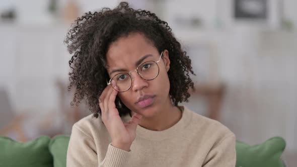 Portrait of Pensive African Woman Thinking at Home