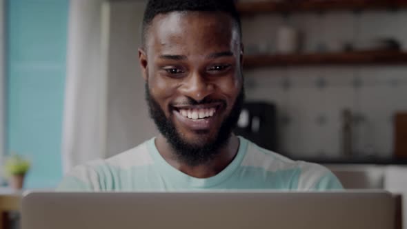 Close Up of Excited AfricanAmerican Ethnicity Man Working on Computer at Home