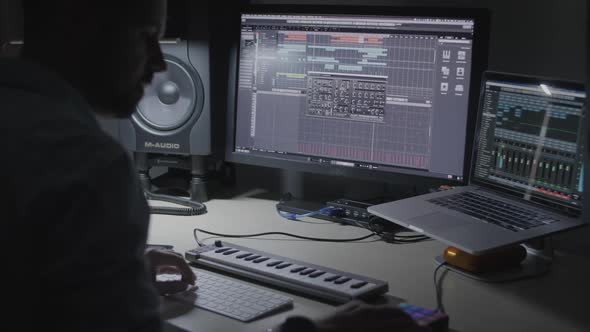 DJ, producer, musician making a beat on a drum pad in a recording studio