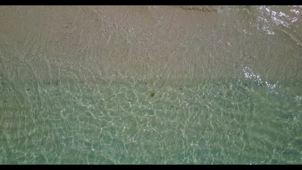 Aerial drone shot panorama of exotic tourist beach holiday by blue sea with clean sand background of