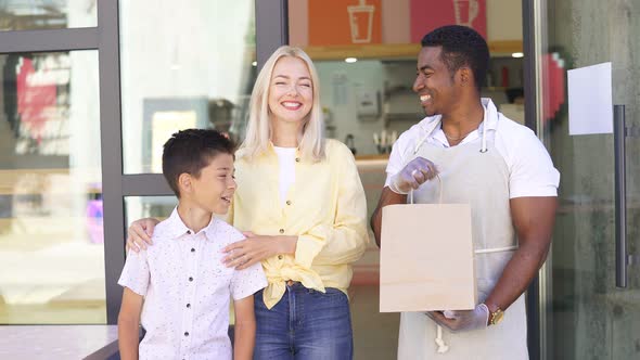 Restaurant Worker Give Takeaway Order in Package To Clients