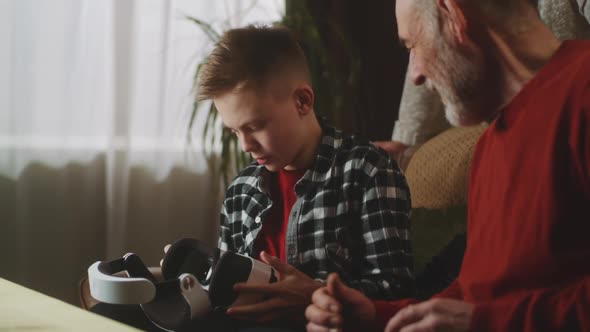 Grandchild Showing Virtual Reality to Grandfather