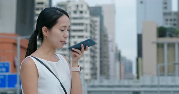 Woman check on cellphone at the station