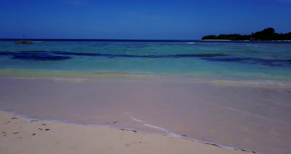 Wide angle fly over abstract shot of a sandy white paradise beach and turquoise sea background in vi