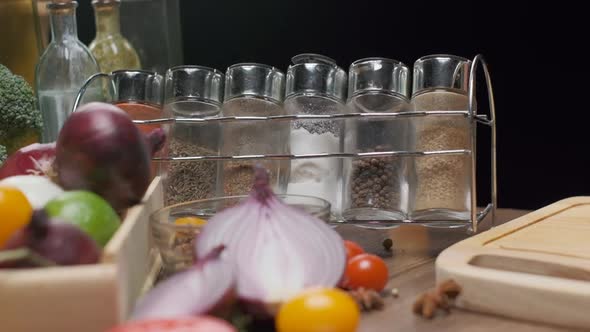 Fresh Vegetables and Spice Jars on the Table