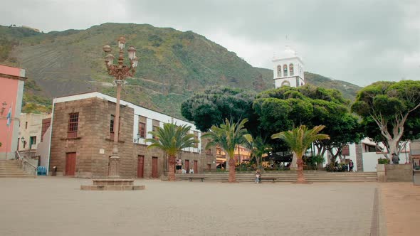 Tropical Landscape, a Tropical City with Palm Trees. The High Bell Tower of the Temple in the