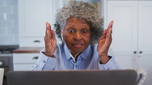 Senior african american female doctor talking while having a videocall at home