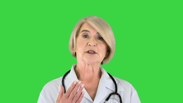 Pleasant Carrying Doctor Lady Talking To Camera on a Green Screen Chroma Key