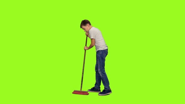 Teen Boy Sweeps the Floor with Mop alt