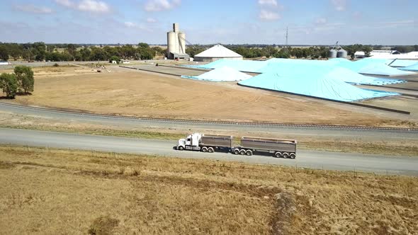 Truck leaving agriculture facility hauling tonnage of agriculture product