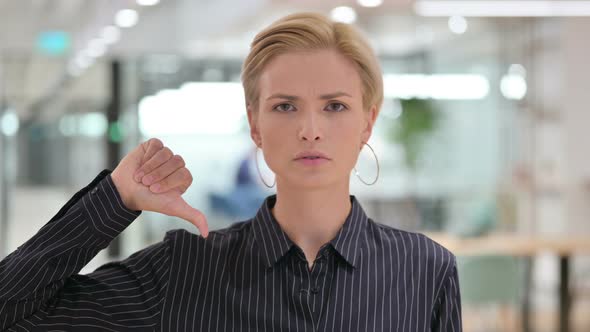 Disappointed Businesswoman Doing Thumbs Down Sign 