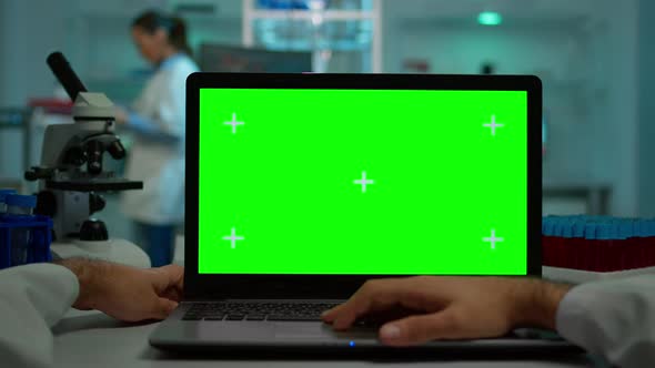 Pov Shot of Microbiologist Typing on Laptop with Green Chroma Key