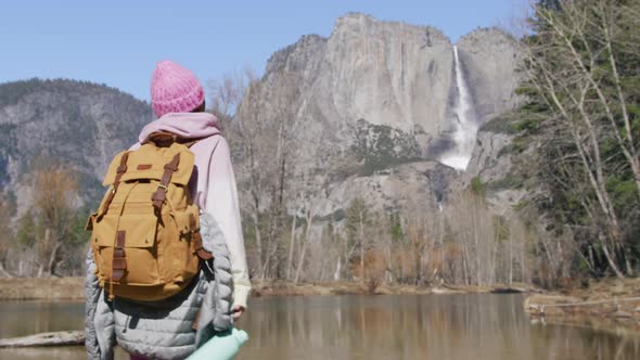 Woman Traveler with Drinking Water Hiking at Mountain River at Mountain Forest