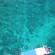 Indonesian fishing boat in turquoise water over beautiful coral reef, aerial - VideoHive Item for Sale