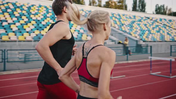 Fitness Couple Running on Urban Stadium Together