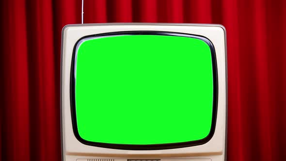 Retro Television with Green Screen Against Velvet Curtain