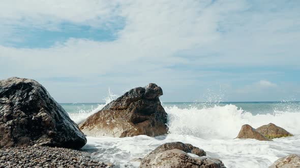 Big Waves Are Crashing on Stones and Spraying in Slow Motion. Beautiful Beach in Crimea with Stones